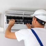 air conditioner maintenance and repair. hvac service technician at work